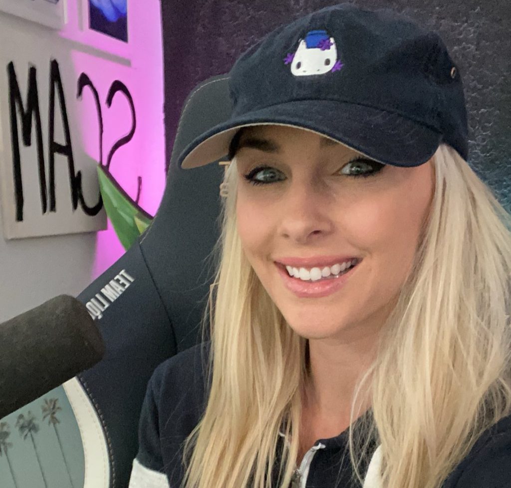 An image of Slysssa with a cap and talking into the mic while streaming.