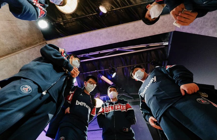 PSG.LGD team huddle at TI10. XinQ is the support player on the squad.