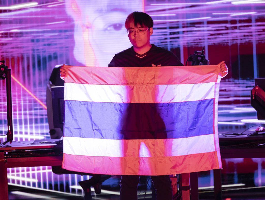 crws holding up a flag of Thailand