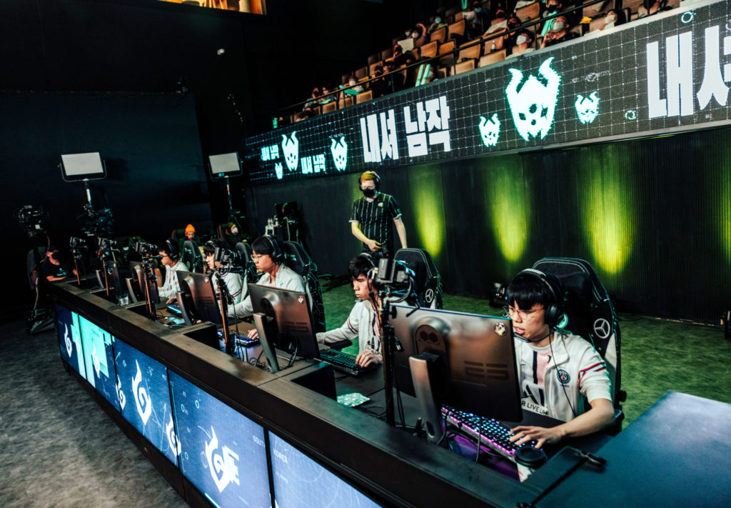 The 5 PSG Talon players sitting at desks under stands.