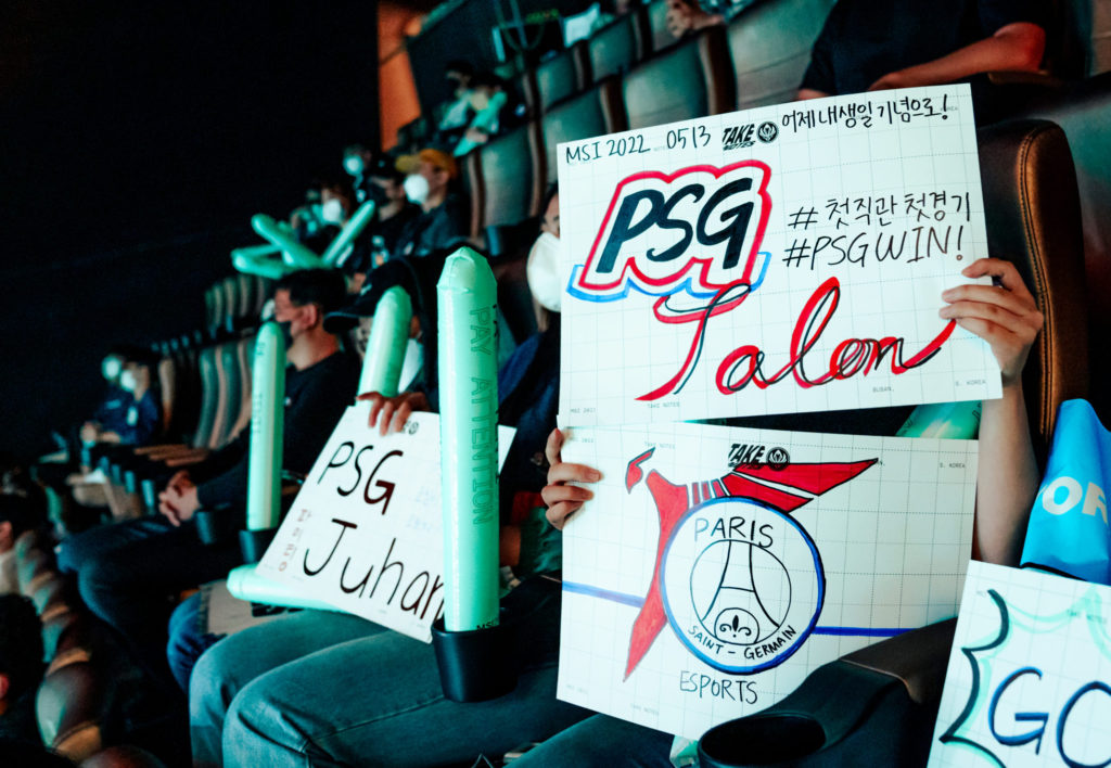 A fan holds up PSG Talon signs. One mentions Juhan.