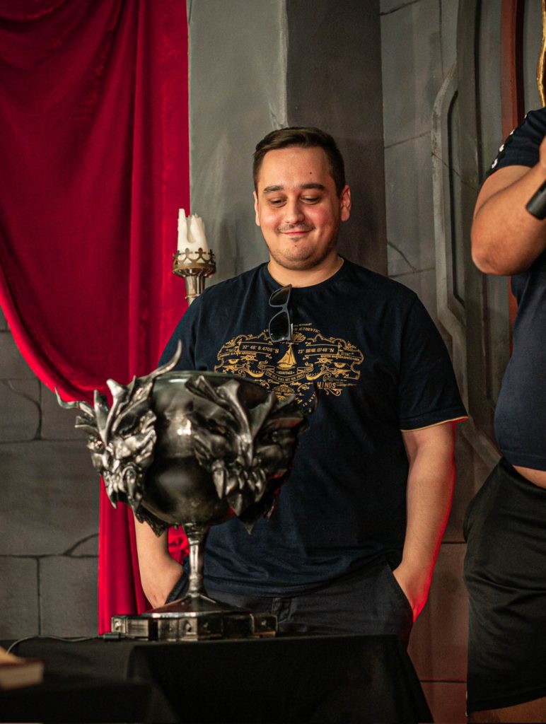 Feno contemplating his Solary Hearthstone party Trophy 