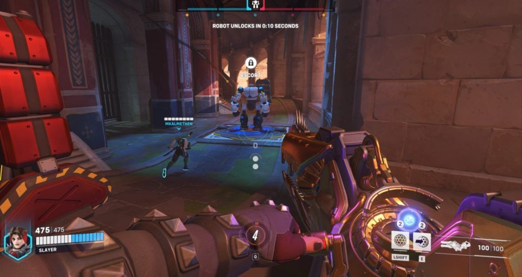The Overwatch 2 Push Mode features a robot, TS1, pushing a barricade to the enemy's base.
