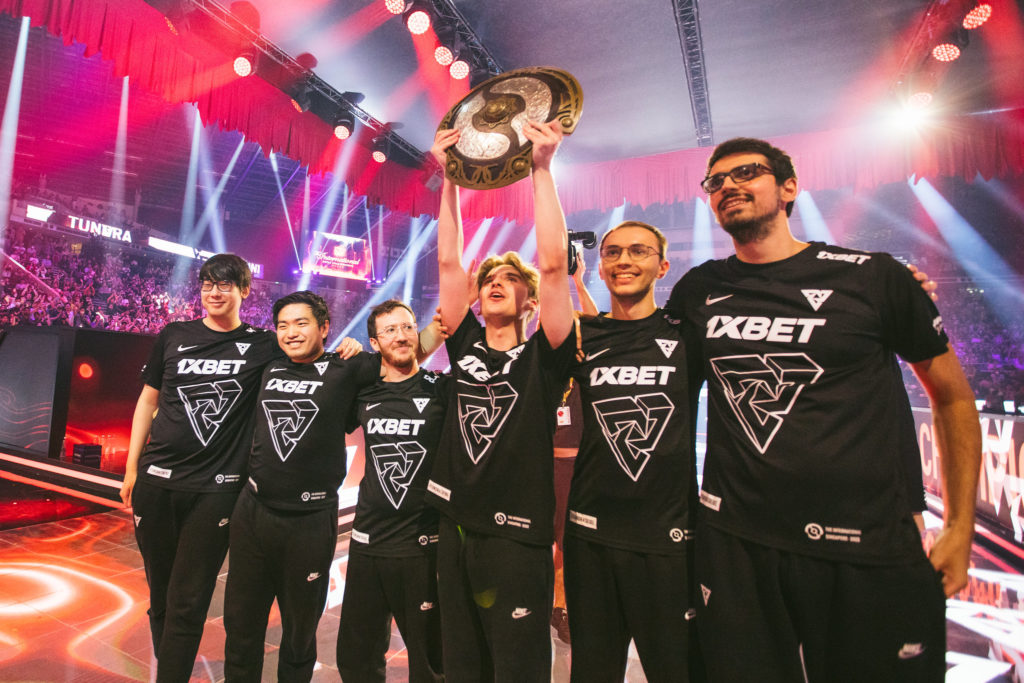 Tundra Esports after their TI11 win. Skiter is seen lifting the aegis at the Singapore Indoor stadium in front of thousands of Dota 2 fans.