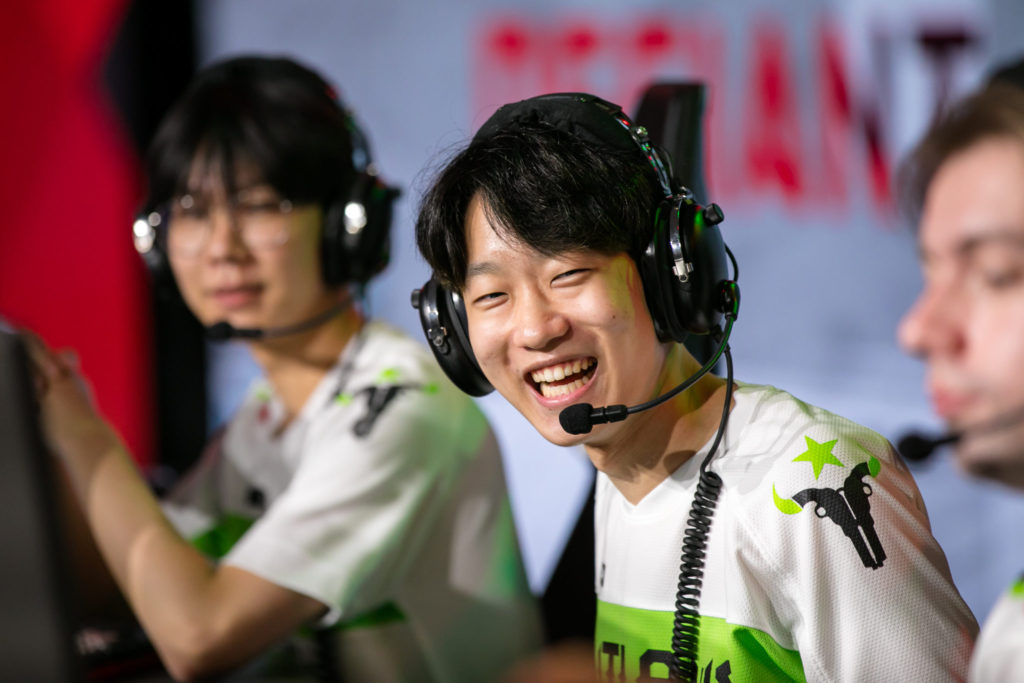 Houston Outlaws players smiling at each other after an insane play  live at the Anaheim Convention Center. They are competing in the Overwatch League 2022 playoffs.