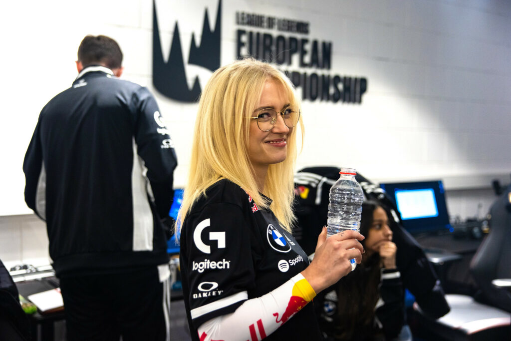 G2 mimi holding water and smiling at the camera