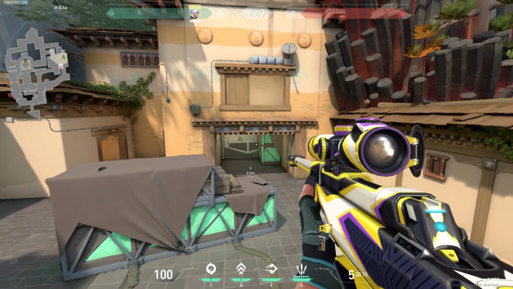 Jett stands on a box on Haven's A Site, looking at the Hell area with an Operator.