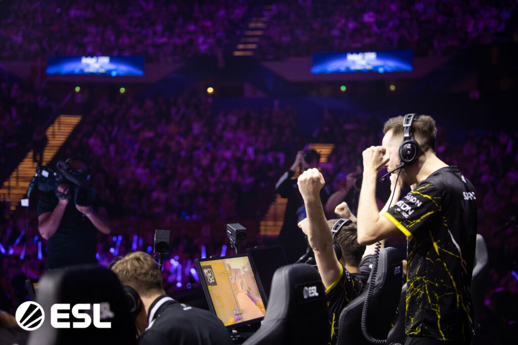 NAVI coach celebrating as he watches his team win a match