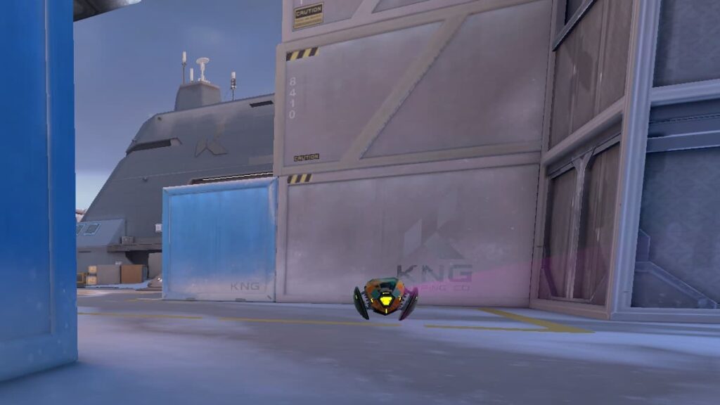 Raze's Boom Bot in VALORANT moves down the mid lane of the Icebox map.