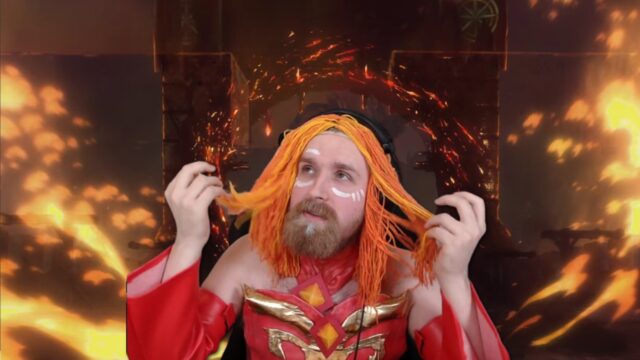 TeaGuv, cosplaying as Lina, is writing down every hero’s stats before Dota 2 Patch 7.33