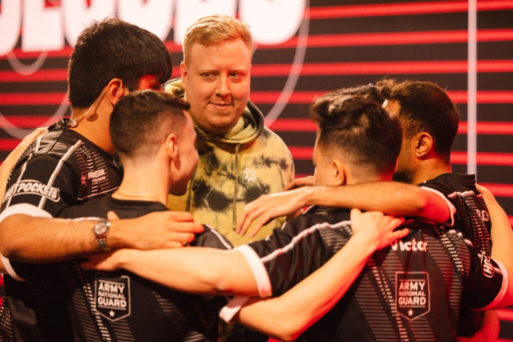 NRG and ardiis huddle onstage before competing during Week 4 of 2023 VCT Americas at the Riot Games Arena on April 23, 2023.