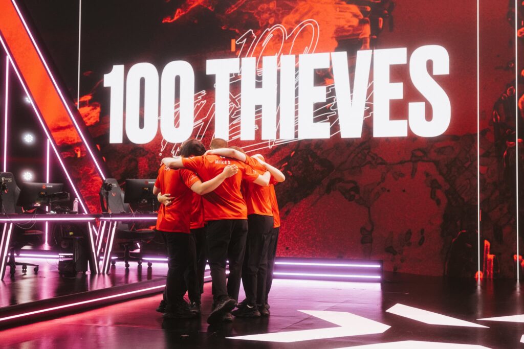 100 Thieves huddle onstage before competing during Week 8 of 2023 VCT Americas at the Riot Games Arena on May 20, 2023.