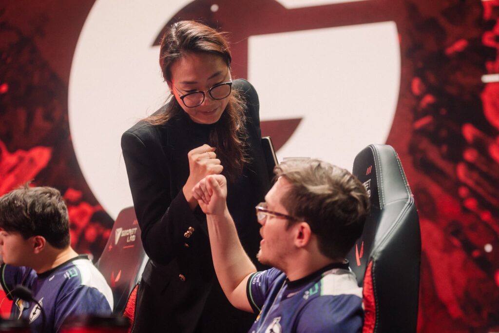 Coach Christine "potter" Chi (L) and Kelden "Boostio" Pupello of Evil Geniuses fist bump onstage while competing during Week 8 of 2023 VCT Americas at the Riot Games Arena on May 18, 2023.