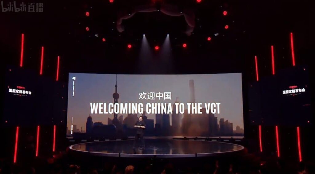 Whalen Rozelle stands on stage as an image in the background says "Welcoming China To The VCT."