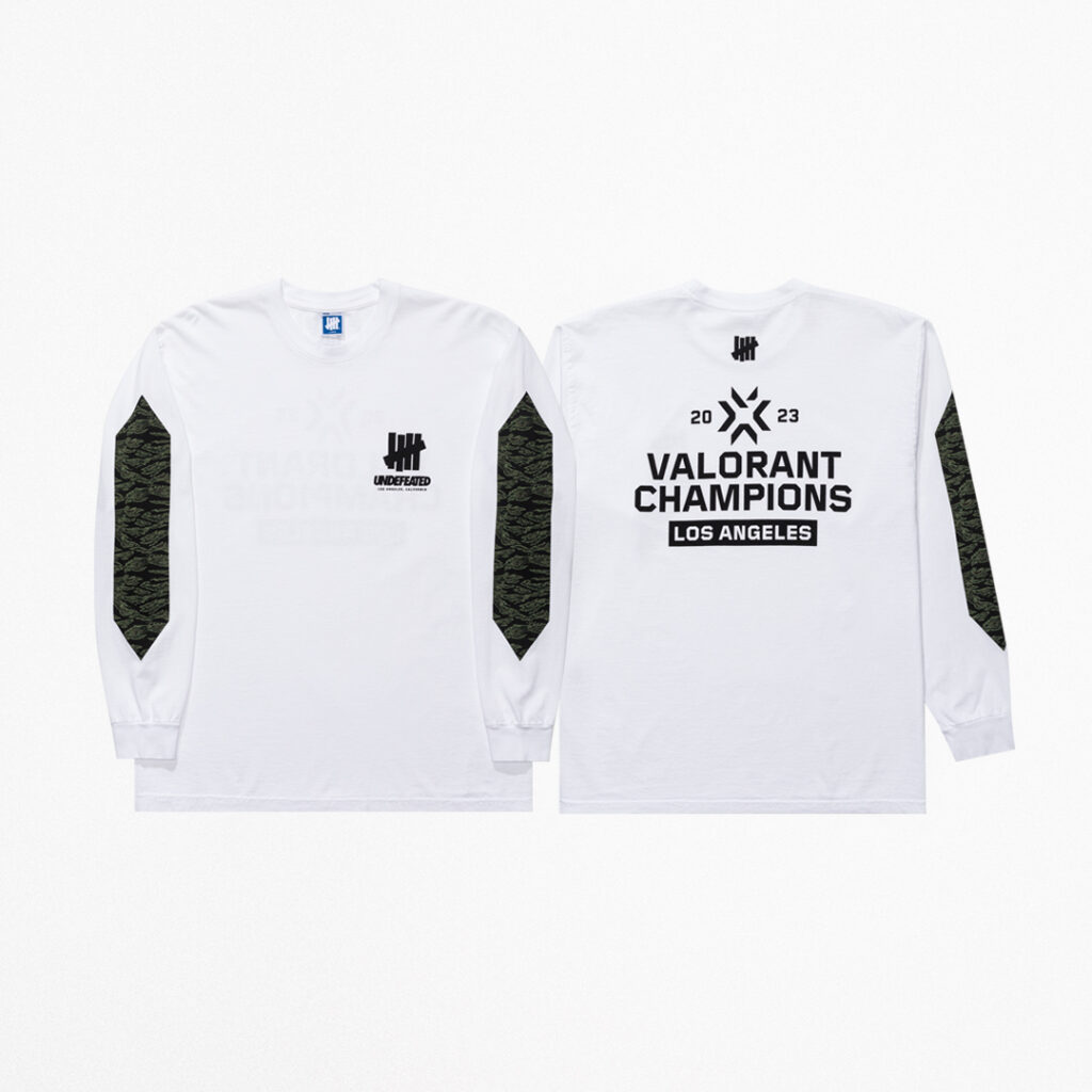 The front and back of the white and black long-sleeve tee from the VALORANT Champions x UNDEFEATED capsule collection.