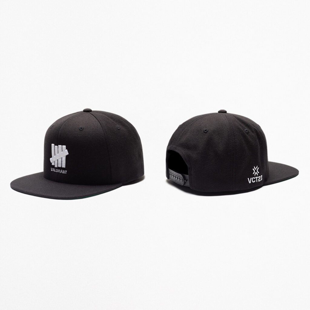 The front and back of the black snapback hat from the capsule collection.