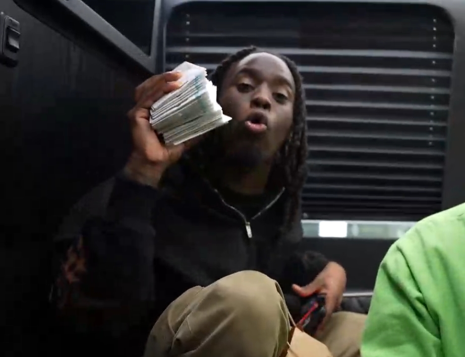 Kai Cenat Riot: Streamer holding a stack of $100 gift cards.