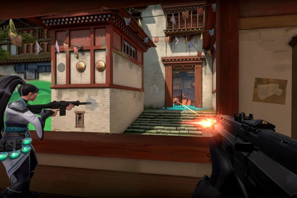 A player and Sage shoot their weapons through the mid window on Haven shortly after VALORANT released.
