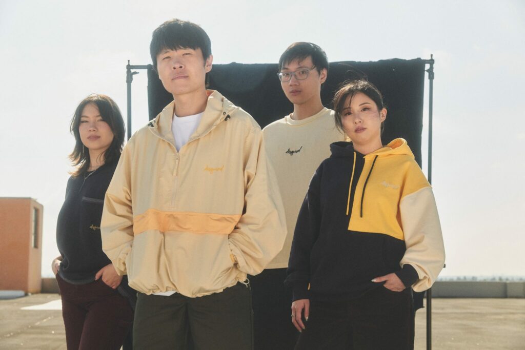 Models pose with the new Disguised merch Classic Capsule.