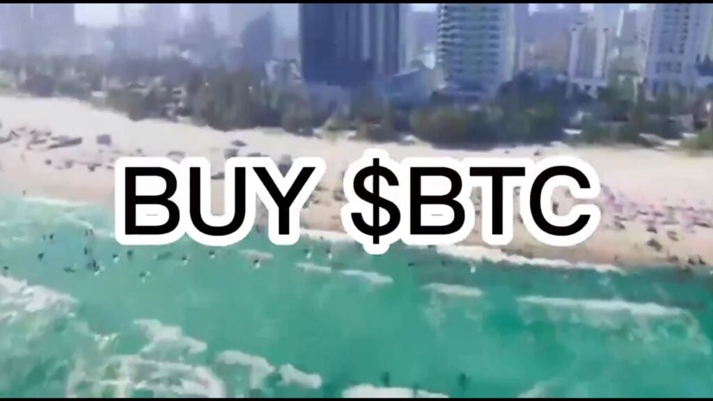 The BUY $BTC watermark sits over a beachfront in the trailer for GTA 6.