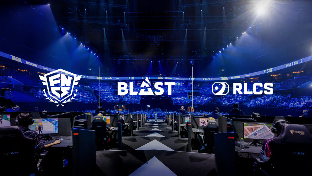 Players play Fortnite on stage with a packed arena looking on as the BLAST logo, FNCS logo, and RLCS logo appear as part of the Epic Games partnership.