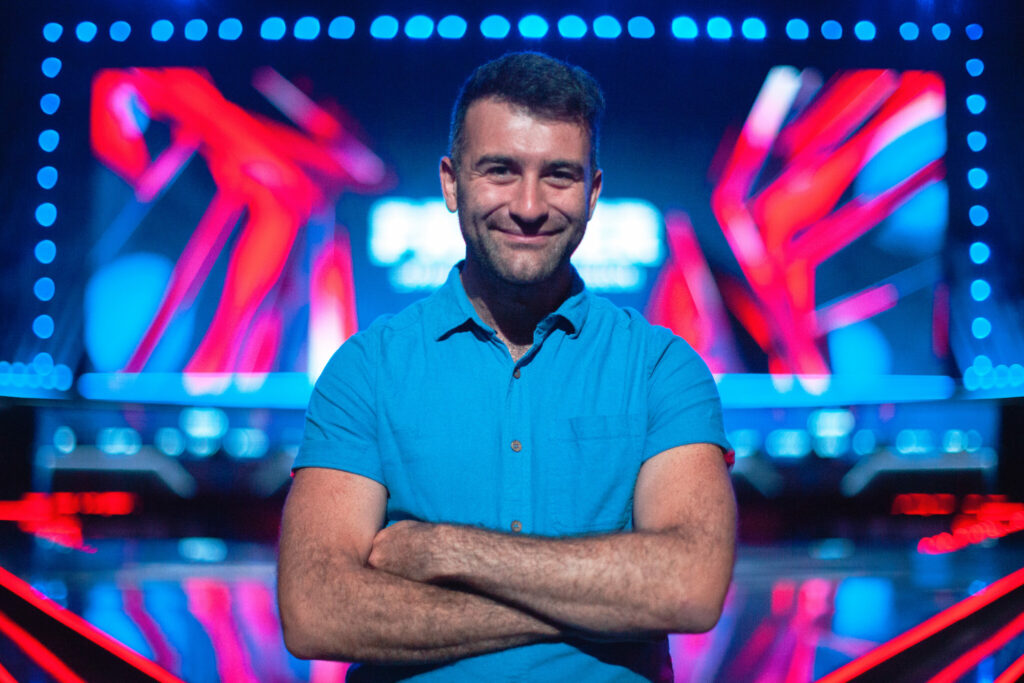 Leo Matlock, Chief Business Officer at BLAST, smiles and stands with his arms folded.