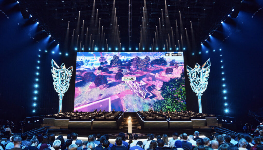 Fans watch the big screen as it shows Fortnite game during BLAST's FNCS event.