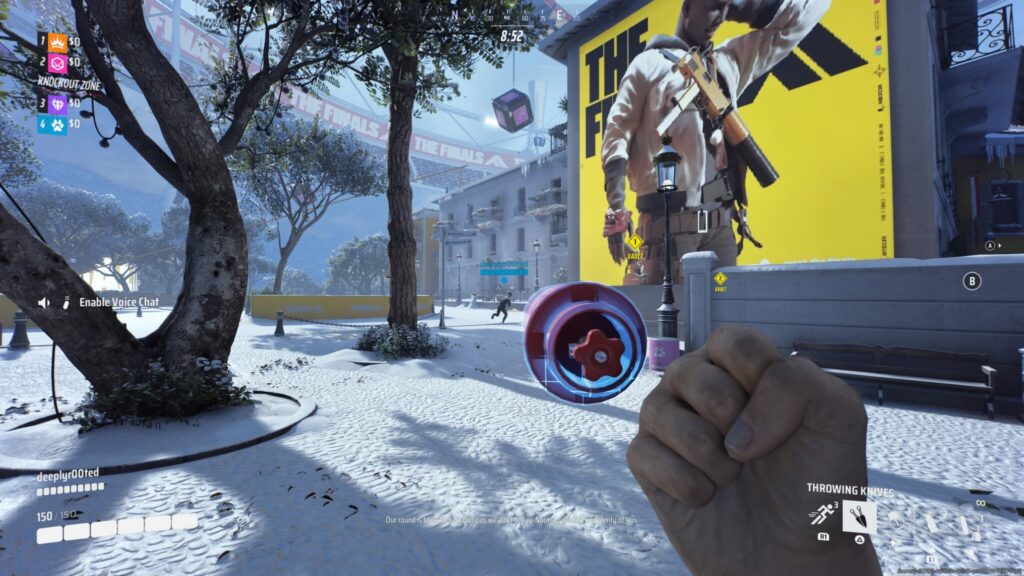 A player picks up an arena carriable in The Finals, an explosive cylinder.