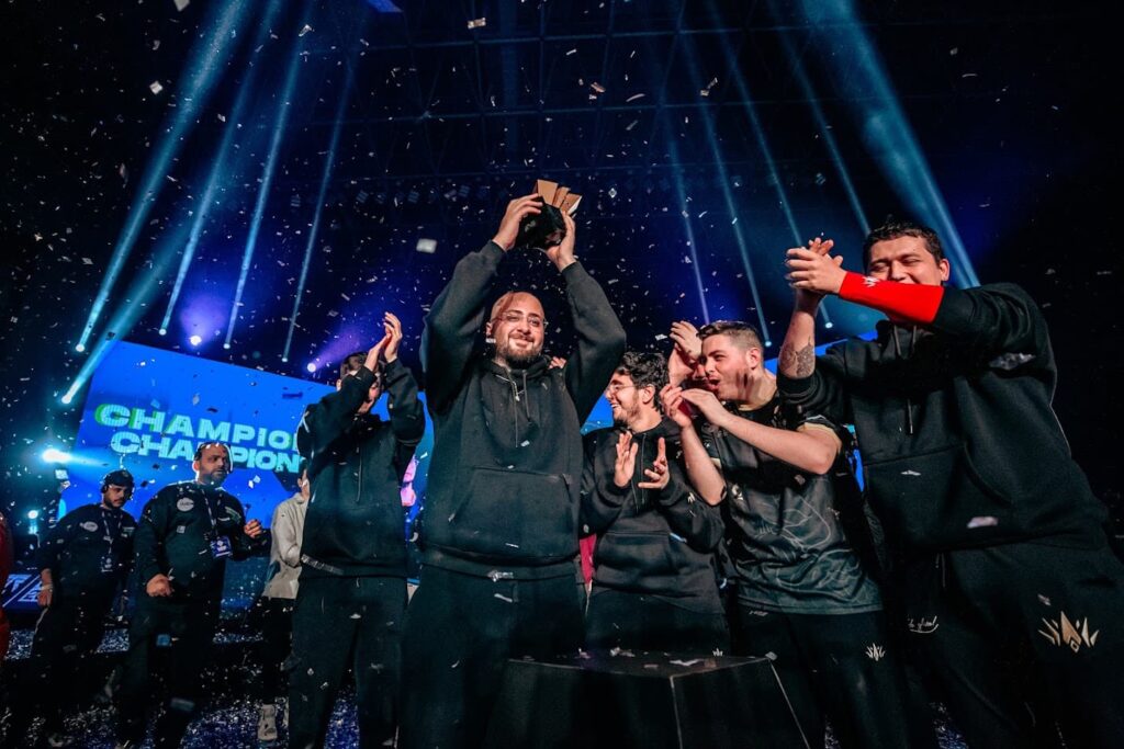 BBL coach Epic lifts a trophy while his players celebrate.