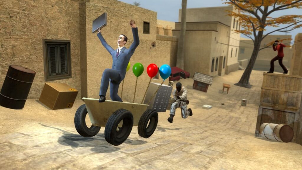 The G Man rides a cart while a CT runs behind it in Garry's Mod, on a Counter-Strike map.