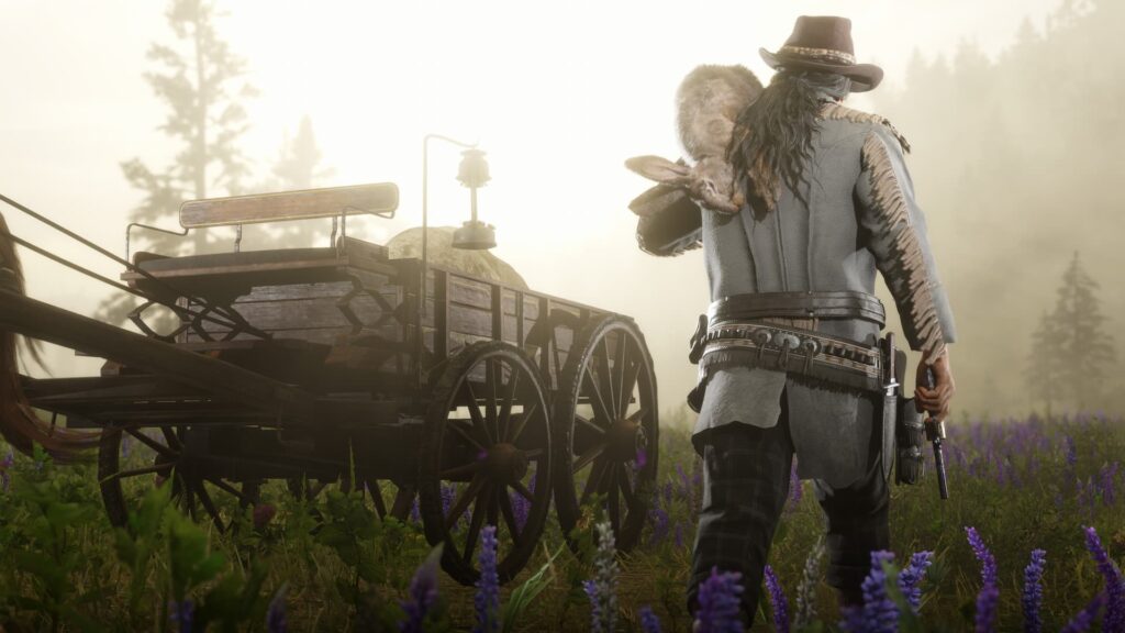 A player carries a rabbit they hunted to their carriage in Red Dead Online.
