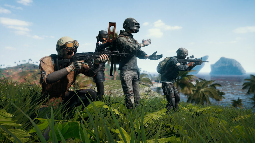 The screenshot shows four PUBG Battlegrounds characters next to each other. They're standing on green grass.