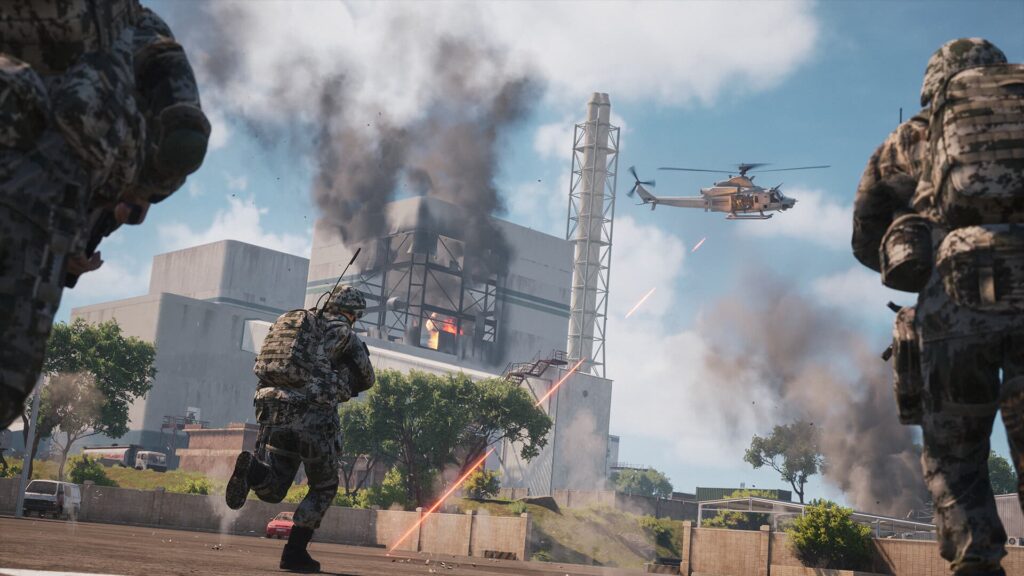 Soldiers push towards an attack helicopter and a factory in Squad.