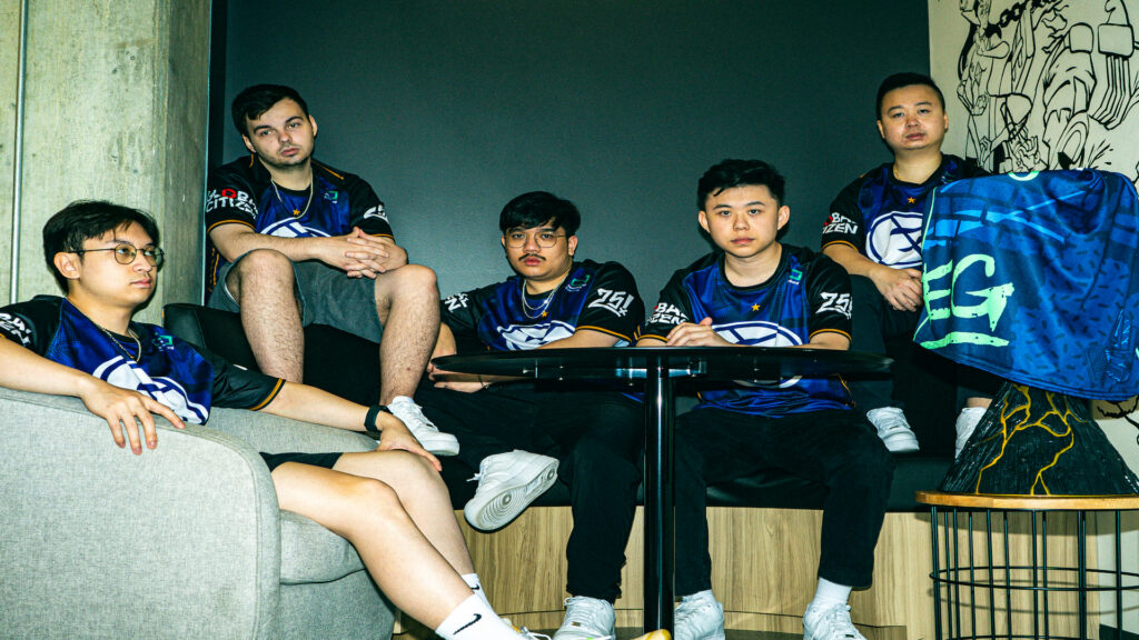 Three Evil Geniuses' VALORANT players wearing a jersey featuring the old logo.