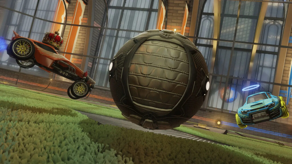 Two opposing cars trying to hit a ball during a Rocket League Competitive match.