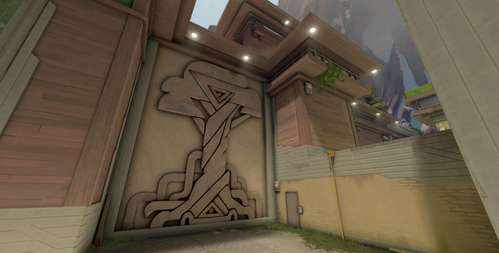 A ledge with a wood-carved tree symbol.