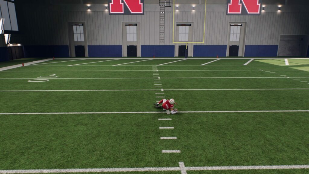 A QB slides in College Football 25.