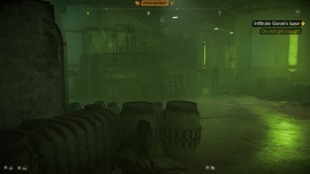 Kay Vess crouches behind containers.