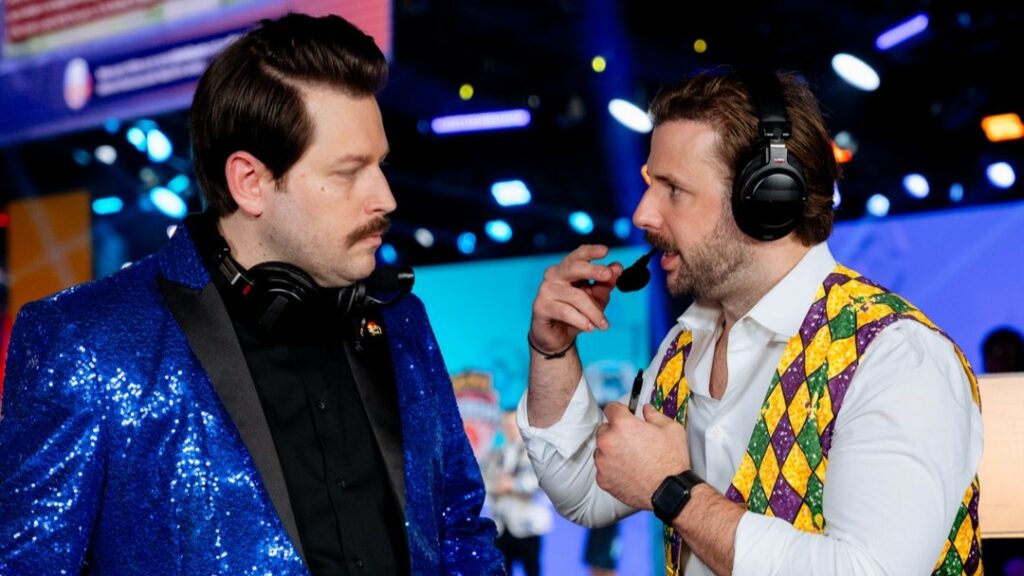 Pokémon UNITE casters Spragels and Doobsnax wearing extravagant suits.