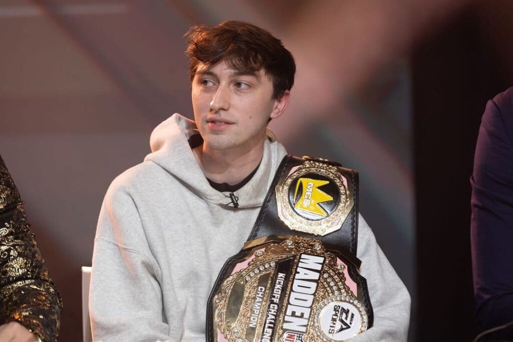 Fancy, who gives us our Madden tips, sits at the desk with his belt after winning the MCS Kickoff Challenge.