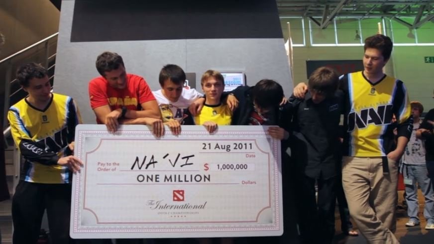 NaVi stand holding a check for a million dollars after winning TI1, starting the list of all TI winners.