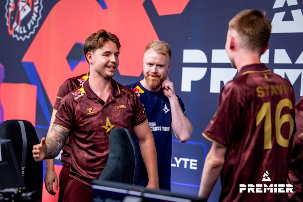 Device and stavn shake hands after a win at a BLAST CS2 event.