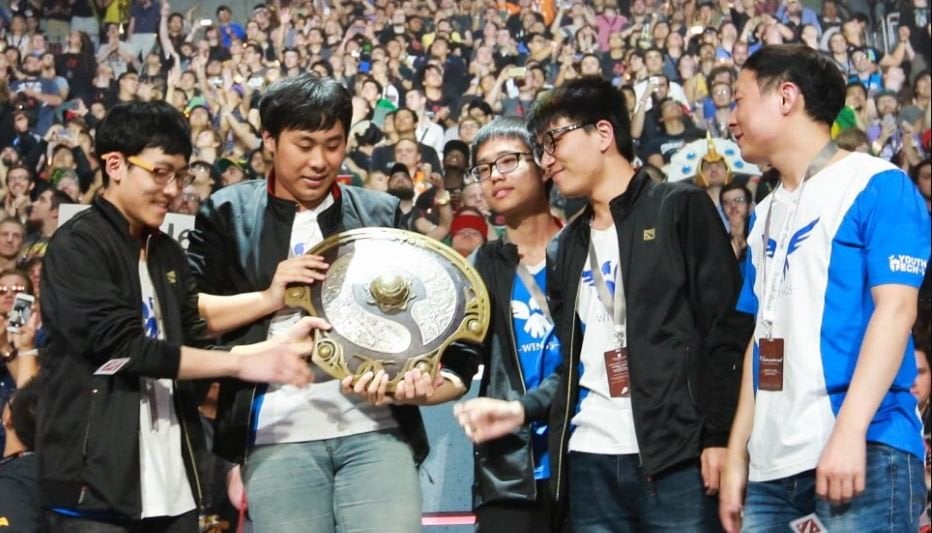 The Wings Gaming team hold the Aegis after a great win at TI 2016.