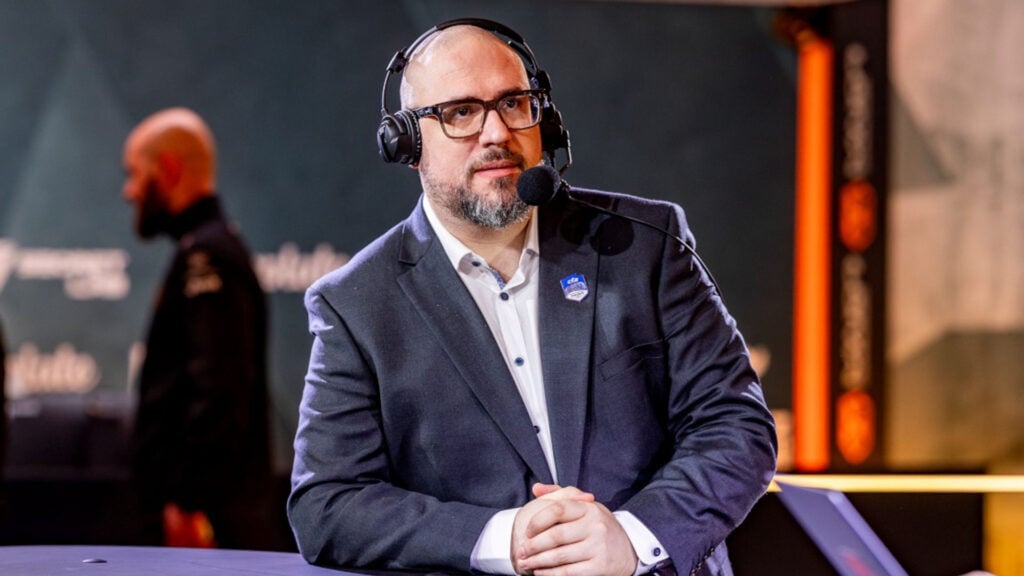 Photo taken of RIchard Lewis during the PGL Copenhagen CS2 Major in 2024. He's a bald middle-age man with glasses.