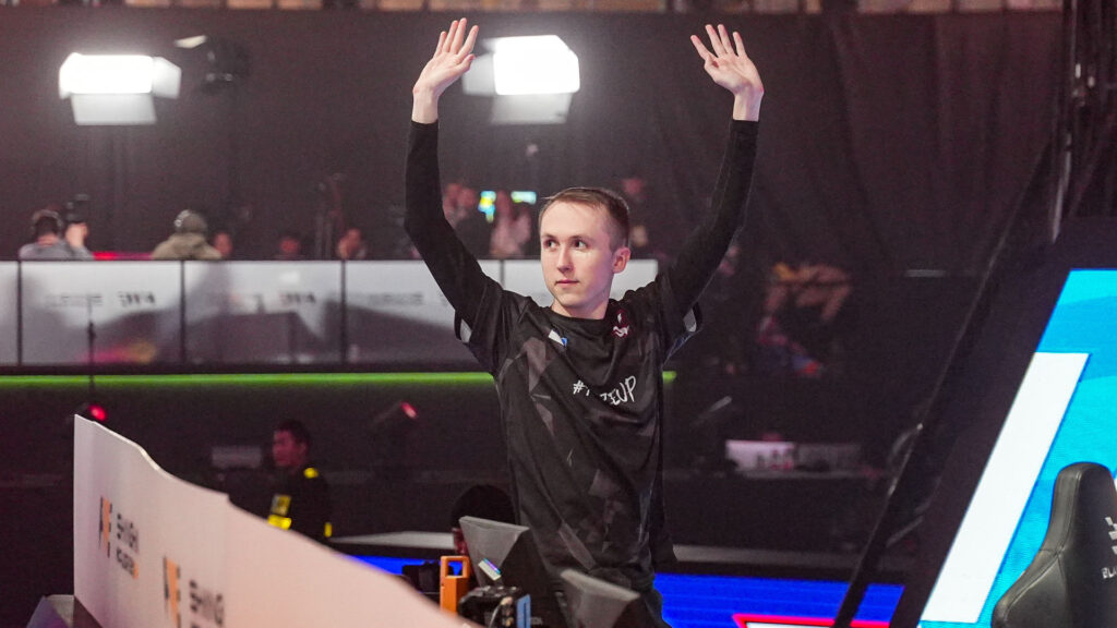 Photo taken of ropz, a male CS2 player. He put both his hands up to celebrate FaZe Clan's victory at the Shanghai Major playoffs.