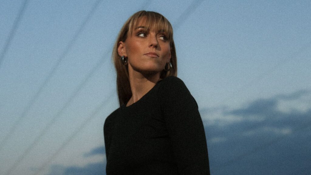 A photo of Sasha Alex Sloan, who is featured in the deluxe extended edition of the Arcane Season 2 soundtrack