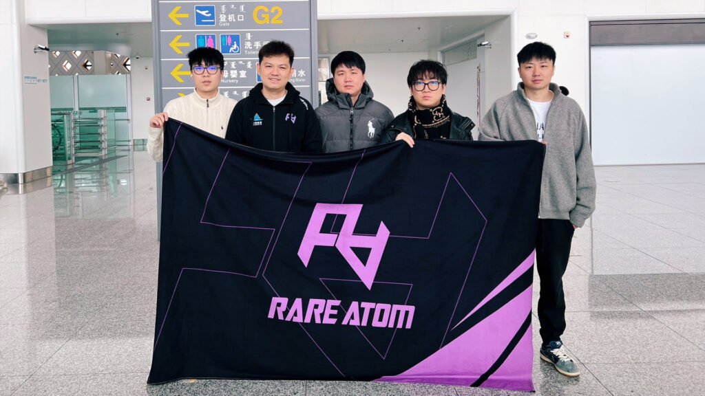 Rare Atom stand holding the team flag at an airport.