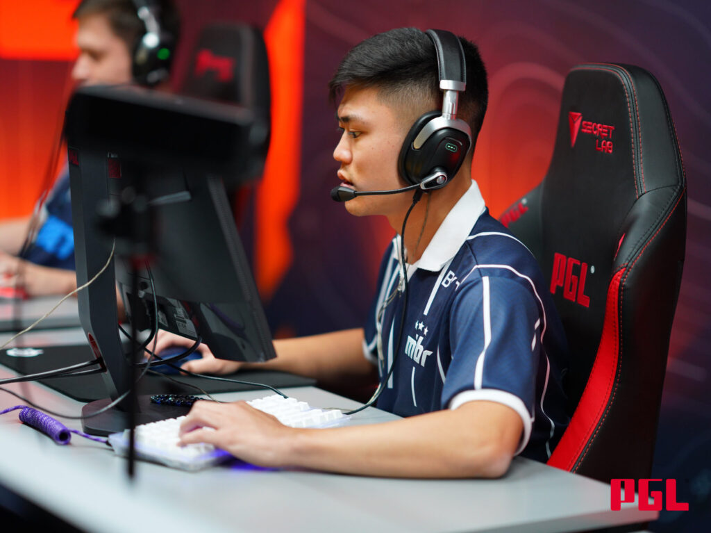 Insani sits at his PC playing CS2