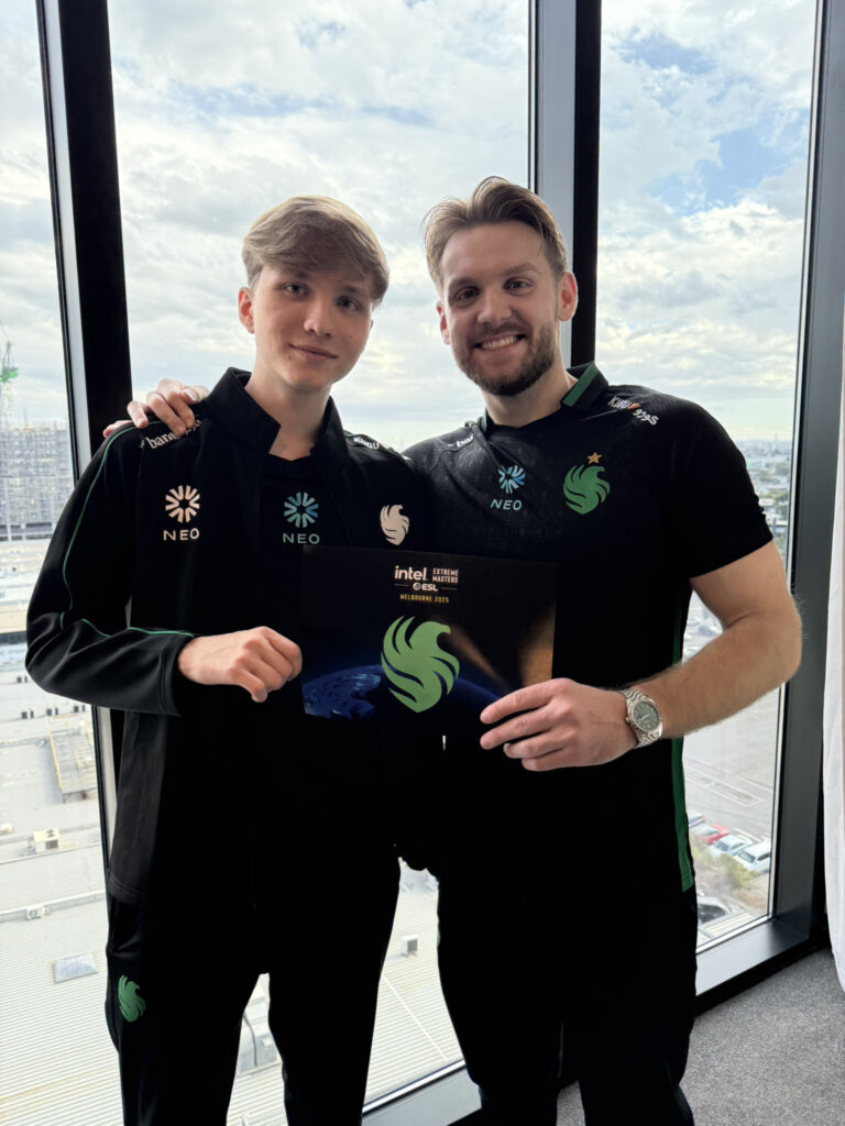 m0NESY and NiKo stand holding the Falcons welcome card at IEM Melbourne.