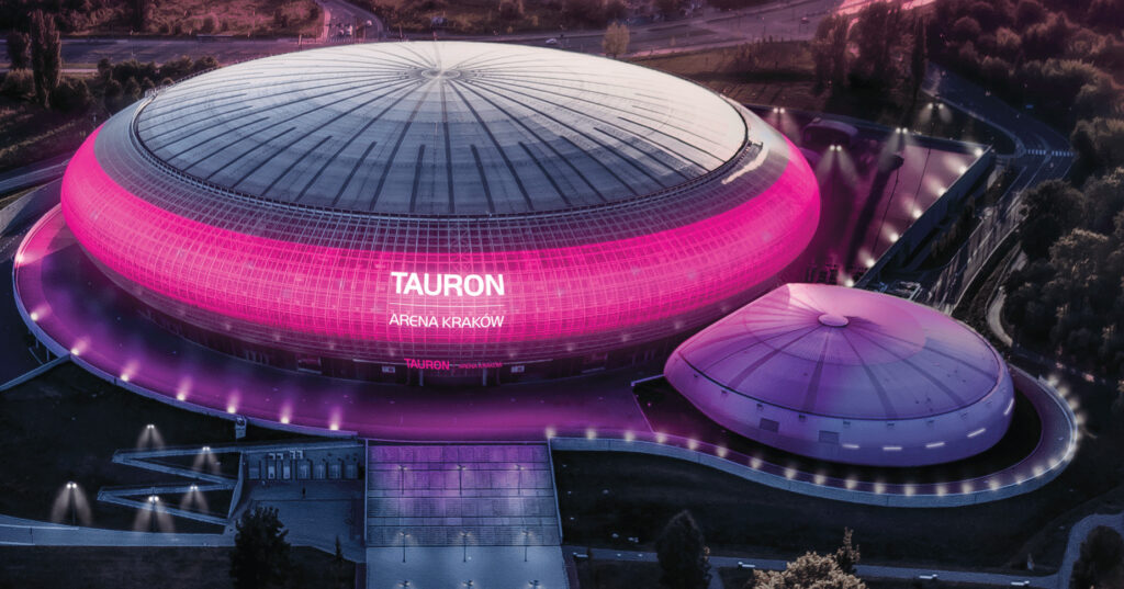 The TAURON Arena in Krakow lit up in pink.